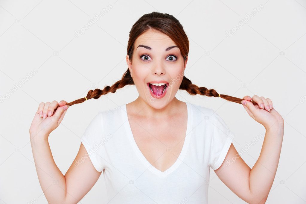 Funny happy girl with two pigtails