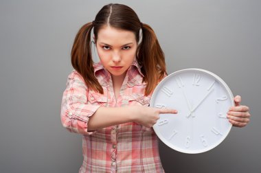 Severe woman pointing at clock clipart