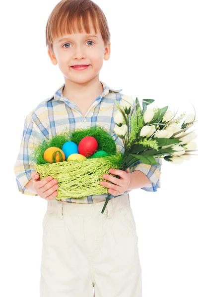 Boy with easter eggs and bunch of tulips — Stock Photo, Image