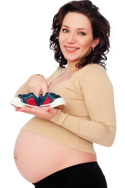 Gravid kvinna anläggning små sneakers — Stockfoto