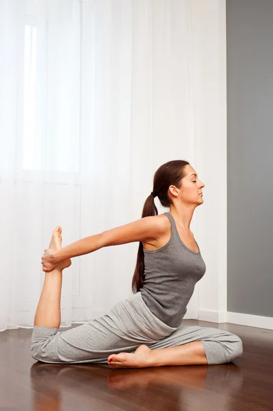 Young woman doing stretch exercise Royalty Free Stock Images
