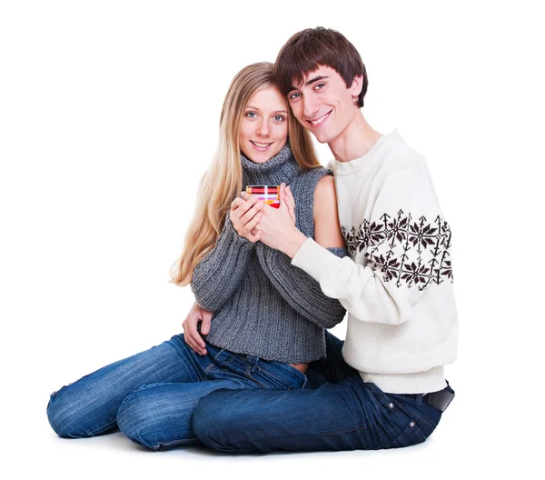 Happy young couple sitting on the floor — Stock Photo, Image