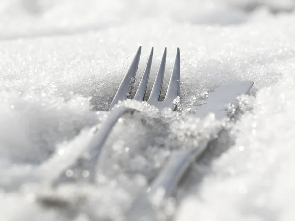 stock image A fork and a knife lying in snow