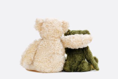 Two teddy bears holding in one's arms clipart