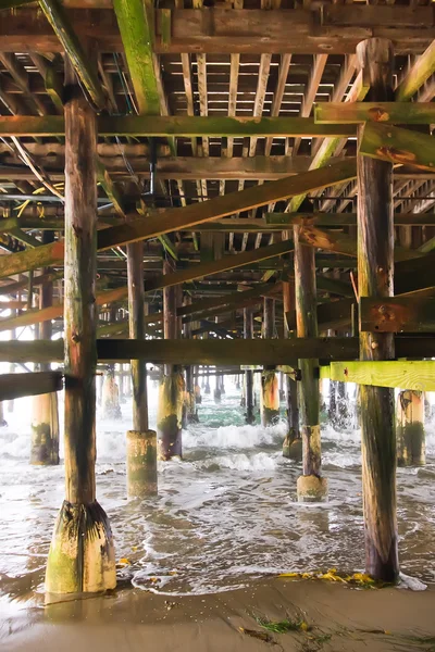 Stock image Under a Fishing Pier along the Ocean