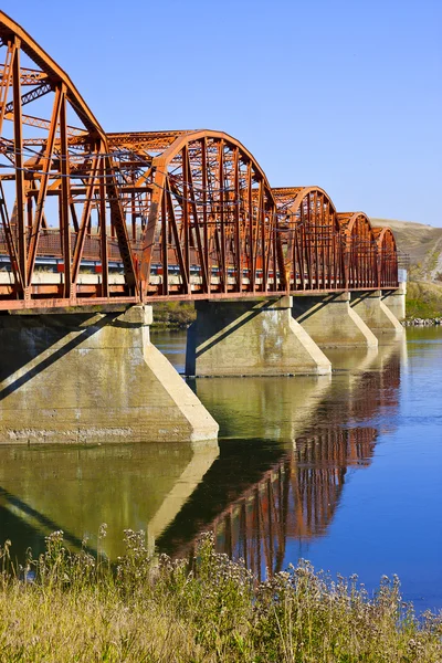 Rote Brücke über den ruhigen Fluss — Stockfoto