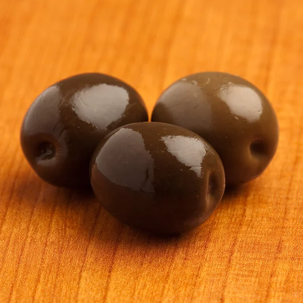 Schwarze Oliven Auf Einer Holzoberfläche Nahaufnahme — Stockfoto