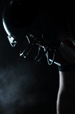Backlit portrait of american football player