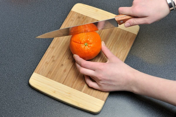 stock image Slicing orange on a table