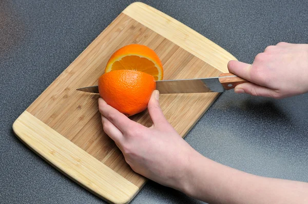 stock image Slicing orange on a table