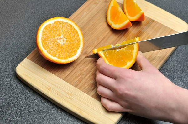 stock image Slicing orange on a table