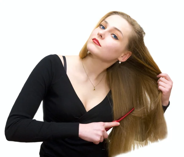 Mladá dívka hřebenů vlasy — Stock fotografie