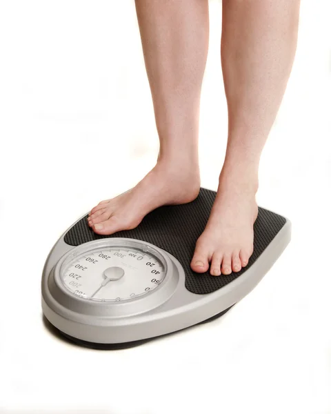 Stopy na skali wagi — Zdjęcie stockowe
