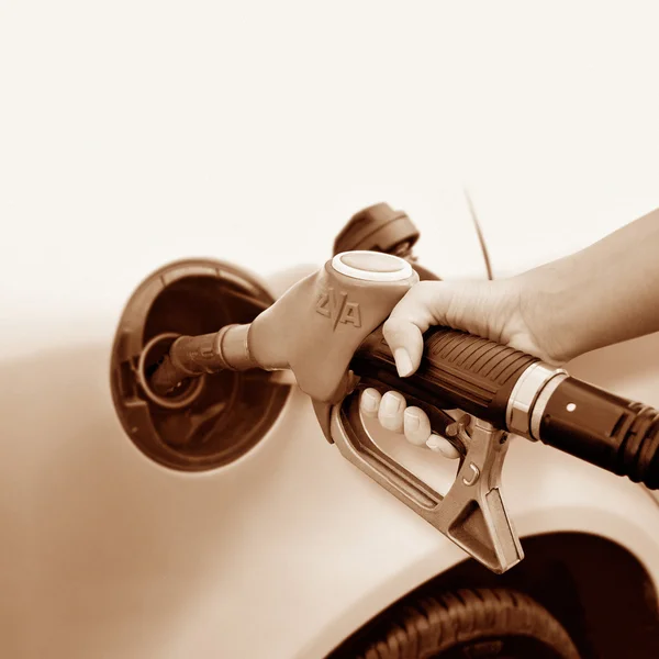 stock image A woman's hand taking gas - sepia tone