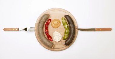 A wooden plate full of sausage clipart