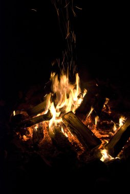 Camp fire burning in the night clipart