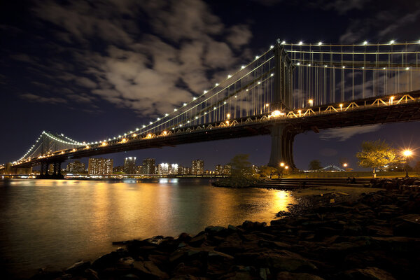 The New York City skyline at twilight w Manhattan Bridge