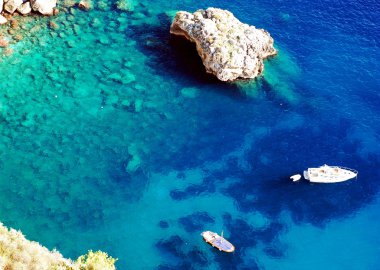 Azure sea at Capri island with boat