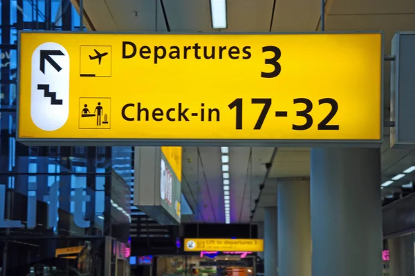 Detailed view of yellow airport departure sign showing direction to gates — Stock Photo, Image