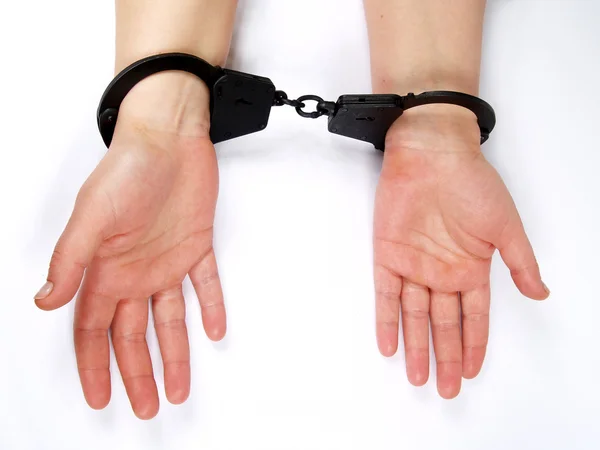 Feminine hands shackled in manacles — Stock Photo, Image