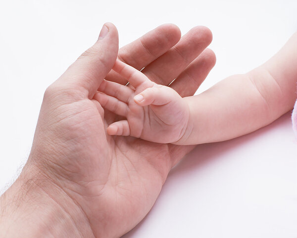 father's and baby's hands on a white background