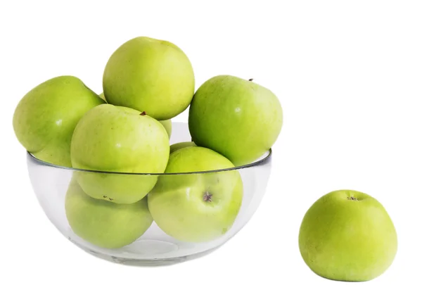 Gröna äpplen i en glasskål Stockbild