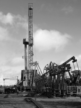 Oil rig in Siberian moor. Black and white photo clipart