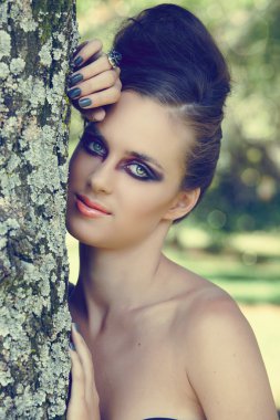 Beautiful woman with dramatic eye make-up clipart