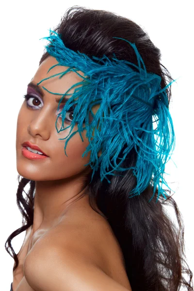 Beautiful tanned woman with a blue feather — Stock Photo, Image