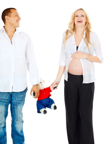 Pregnant couple with toy bear — Stock Photo, Image