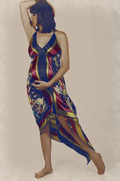 Pregnant woman in long dress — Stock Photo, Image