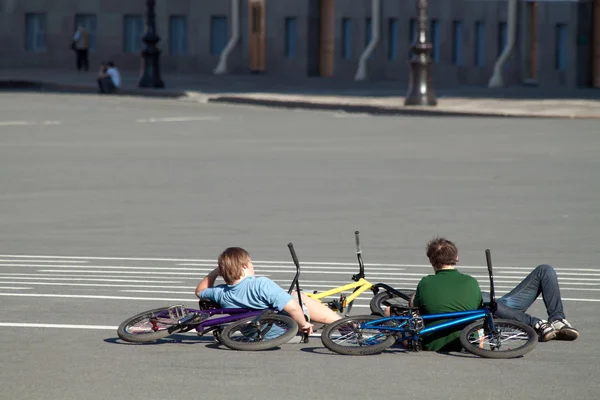 stock image Three boys relaxing on asphalt