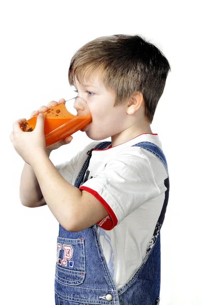 stock image The boy drinking carrot juice