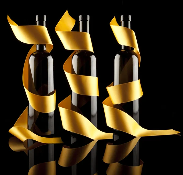 Złote wstążki wokół butelki — Zdjęcie stockowe