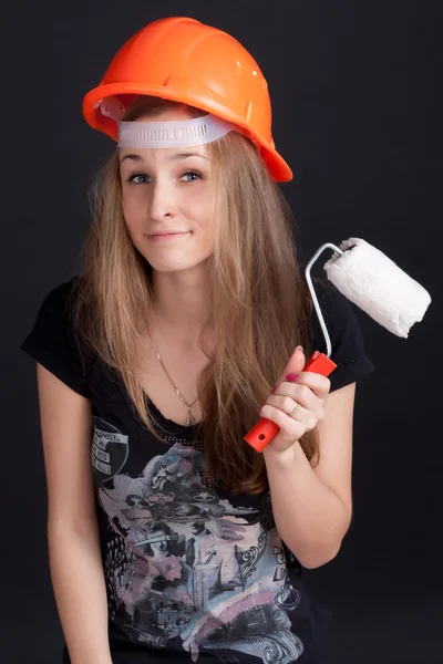 Meisje in een helm met een roller in zijn hand — Stockfoto