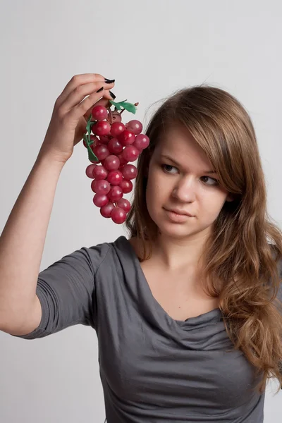 Girl with grapes in his hand — Stock Photo, Image