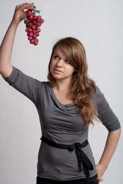 Girl with grapes in his hand — Stock Photo, Image