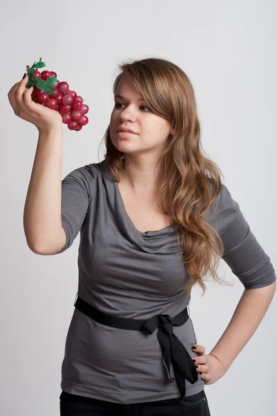 Девушка с виноградом в руке — стоковое фото