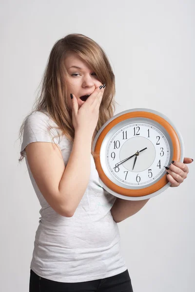Sleeping girl with a big clock in his hands — Stock Photo, Image