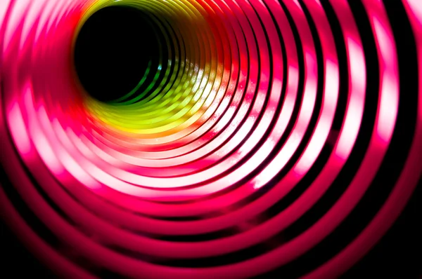 stock image Black hole made from a childs coloured spring