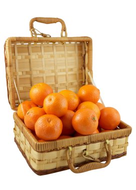 Ripe tangerines in the wicker box over white clipart