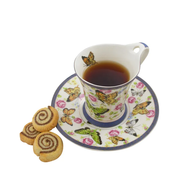 stock image Cup of tea with cookies in the form of a snail