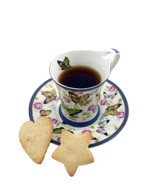 Taza de té con galletas en forma de estrella y corazón — Foto de Stock