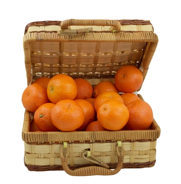 Juicy tangerines in the wicker box over white