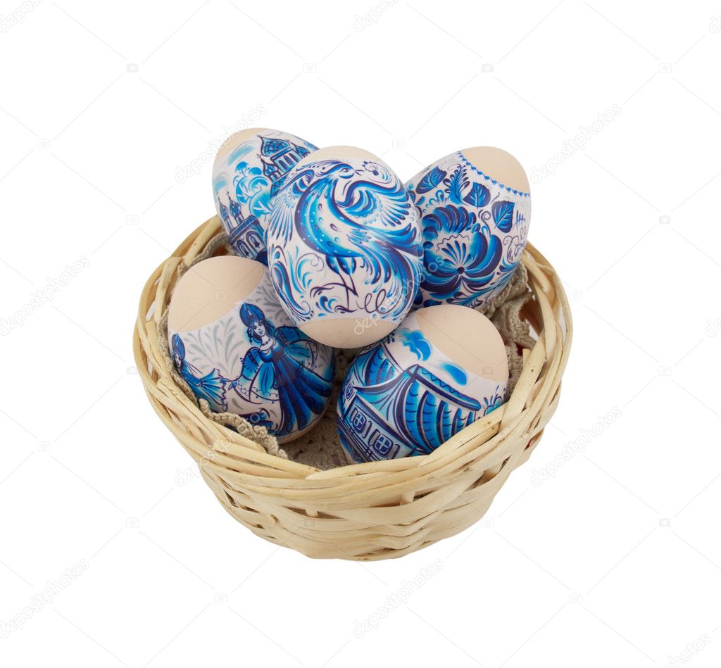 Easter eggs collection in a wicker basket over a white