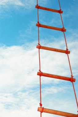 Rope ladder against a blue sky clipart