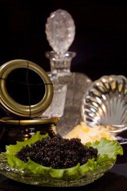 Track with a dish of caviar and a decanter of vodka clipart