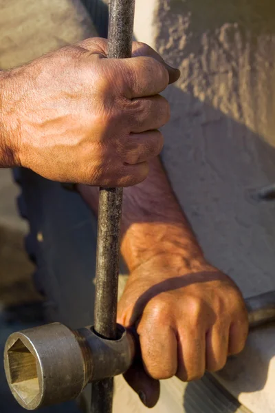 The hands of men working with a lever — Stock Photo, Image