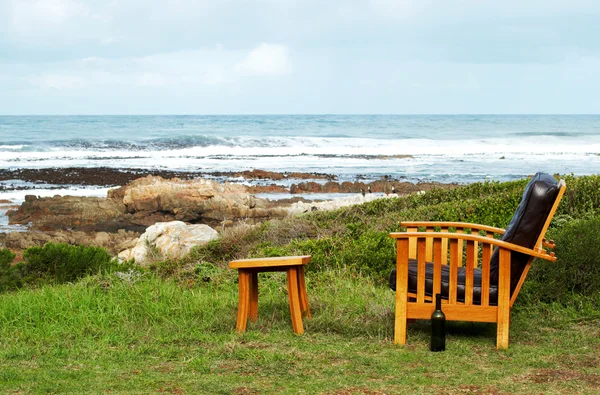 stock image Wooden chair by the ocean