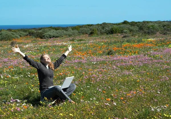 stock image Blonde woman in the field of flowers